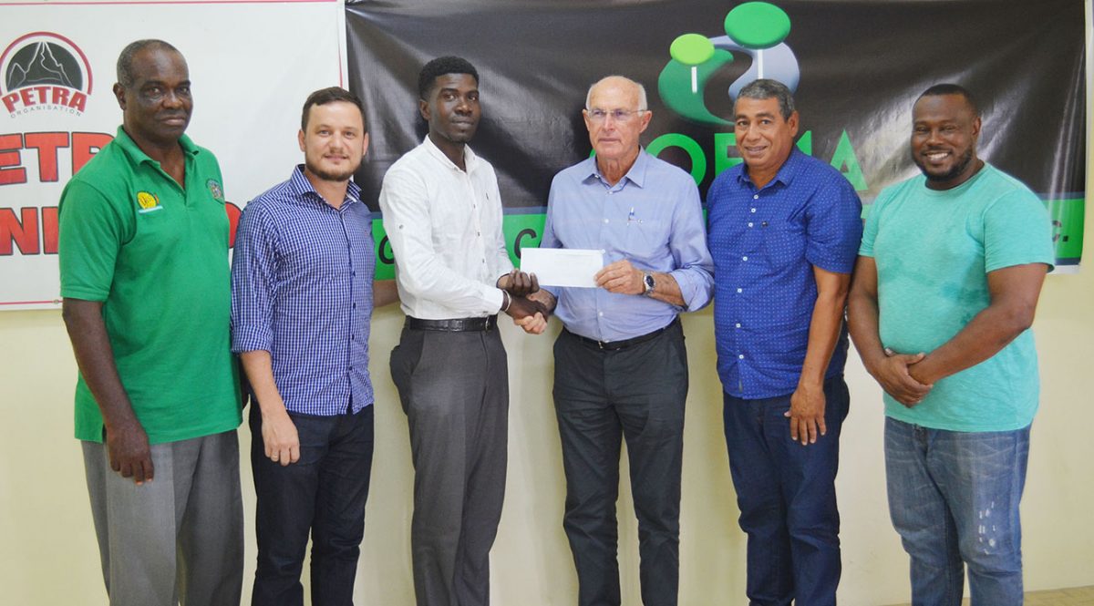 Petra Organisation representative Mark Alleyne collecting the sponsorship cheque from GCCS founder Aurelio Sella. Also in the photo from left to right are Lawrence Griffith; GCCS Admin Manager Marco Salvadore; GCCS Operations Manager Derrick Melville and Petra Organisation Co-Director Troy Mendonca.