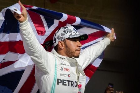  Lewis Hamilton of Great Britain holds up the Union Jack as he celebrates winning his sixth world championship after he finished in second place in the United States Grand Prix at Circuit of the Americas. (Jerome Miron-USA TODAY Sports)
