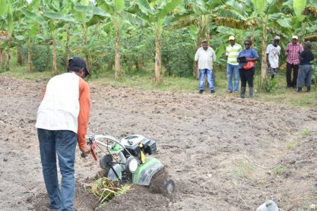 Here’s how it’s done: A Parika farmer demonstrates the use of a Tiller for the benefit of farmers 