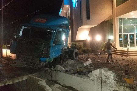 The truck with a trailer that crashed into the fence of the Republic Bank Triumph, East Coast Demerara branch during the wee hours of yesterday morning.