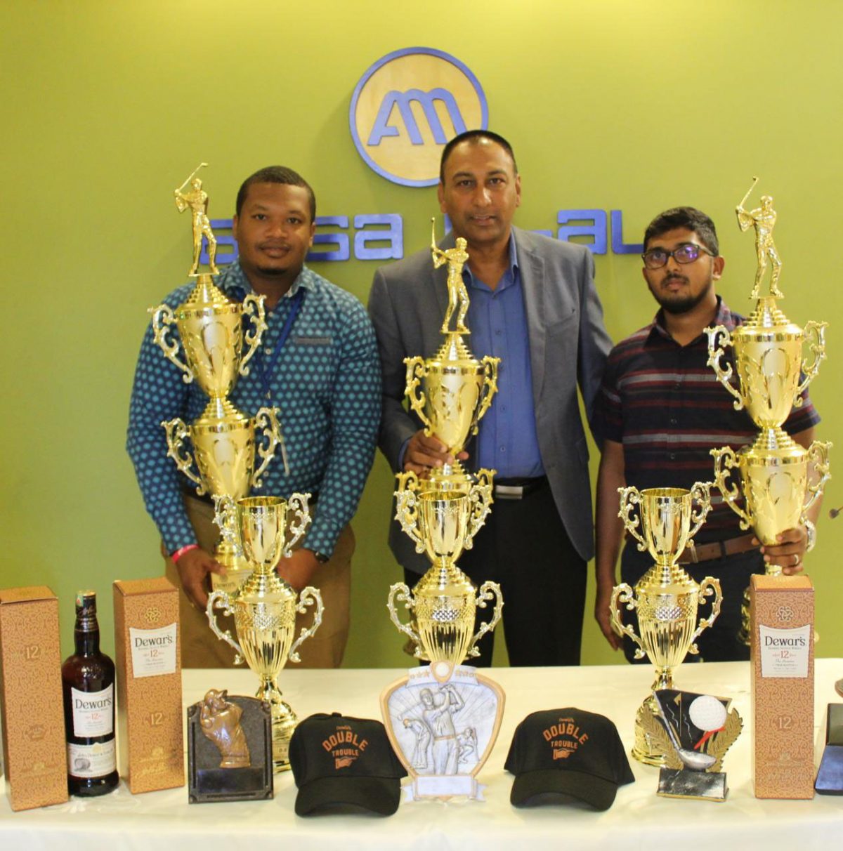 From left are ANSA McAl’s Communications Officer, Treiston Joseph, Lusignan Golf Club President Aleem Hussain and Dewar’s Brand Coordinator Timothy Sammy