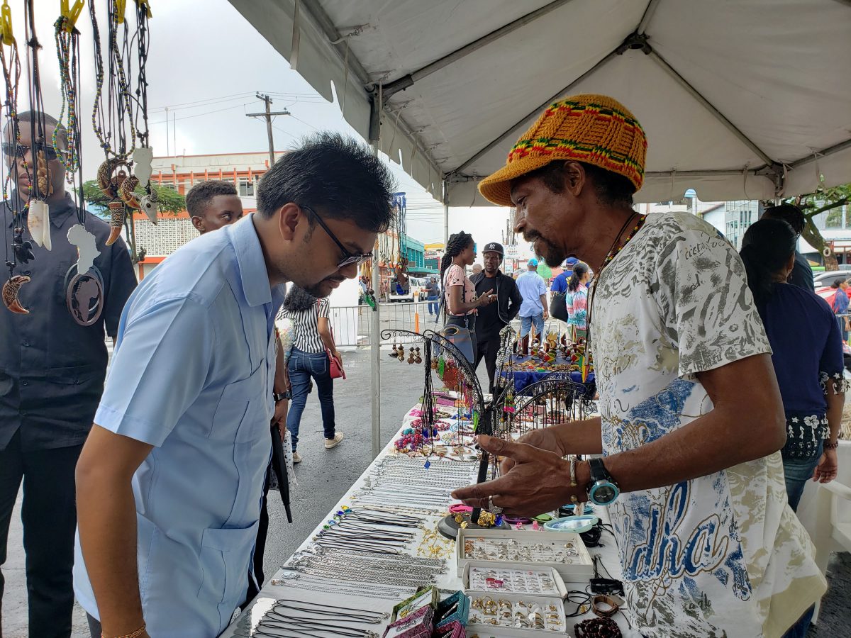 Mayor Ubraj Narine inspecting jewellery made by one of the entrepreneurs at the Small Business Bureau’s Market Day, which was hosted
outside of City Hall yesterday. See story on page 16.
