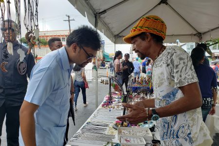 Mayor Ubraj Narine inspecting jewellery made by one of the entrepreneurs at the Small Business Bureau’s Market Day, which was hosted
outside of City Hall yesterday. See story on page 16.
