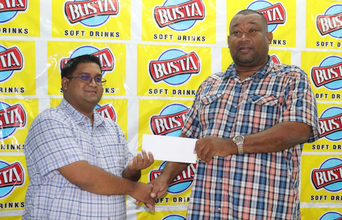 Rose Hall Town Youth and Sports Club CEO/Secretary, Hilbert Foster (right) receives the sponsorship from Guyana Beverage Company’s Brand Manager, Raymond Govinda (Romario Samaroo photo)
