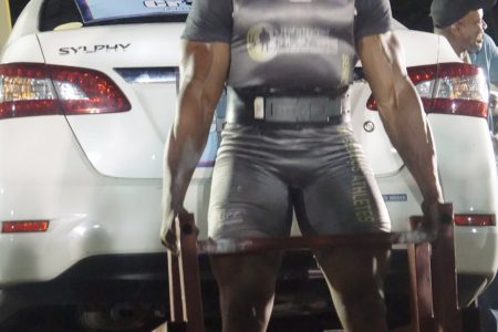 Carlos Peterson-Griffith dead lifted the Nissan Sylphy for 20 reps, part of his show stopping performance at the Cliff Anderson Sports Hall on Sunday night which earned him the top honours in the Guyana’s Strongest Man competition. (Emmerson Campbell photo)
