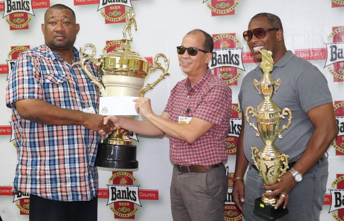 President of the Berbice Cricket Board, Hilbert Foster (left) accepts the sponsorship cheque from Banks Beer Brand Manager, Brian Choo-Hen in the presence of Special Events Manager Mortimer Stewart (Romario Samaroo photo)
