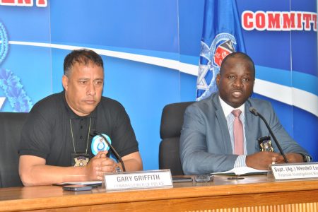 Supt. (Ag.) Wendell Lucas of the TTPS Financial Investigations Branch, right, speaks during a news conference at the Police Administration Building yesterday. At left is Police Commissioner Gary Griffith.