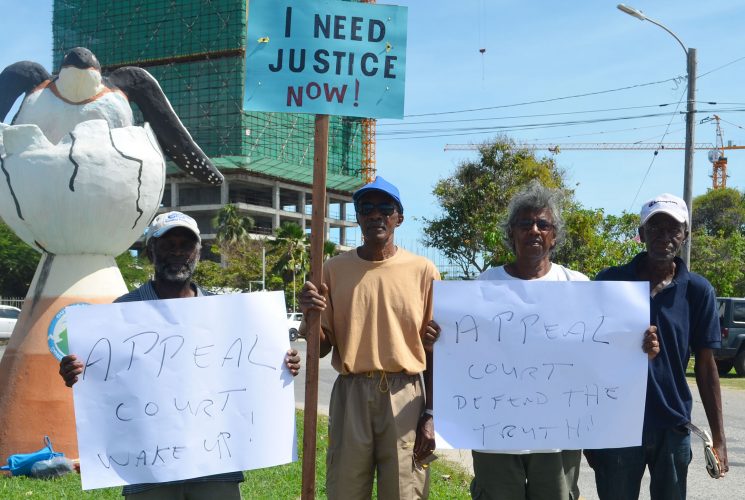 Donald Rodney (second from left) with (from left) Tacuma Ogunseye, Freddie Kissoon and another supporter.