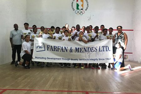 The respective group winners and top four finishers pose with their spoils at the conclusion of the Farfan and Mendes Junior Skill Level Tournament at the Georgetown Club Inc. courts, Camp Street.