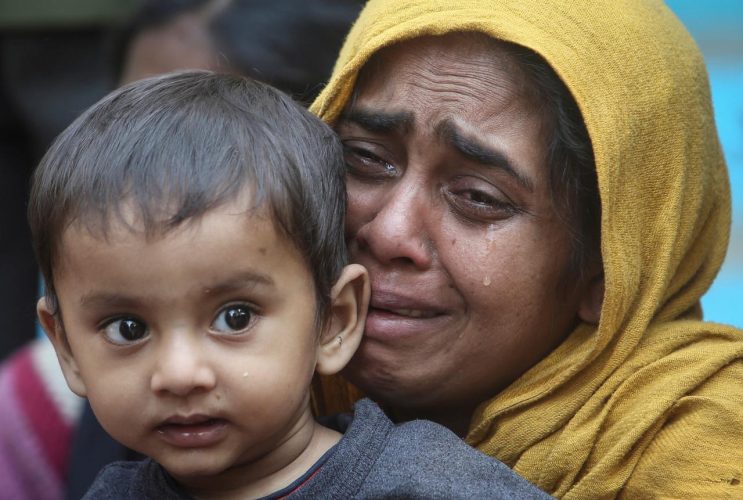 FILE PHOTO: A Rohingya Muslim woman cries as she holds her daughter after they were detained by Border Security Force (BSF) soldiers while crossing the India-Bangladesh border from Bangladesh, at Raimura village on the outskirts of Agartala, January 22, 2019. REUTERS/Jayanta Dey/File Photo