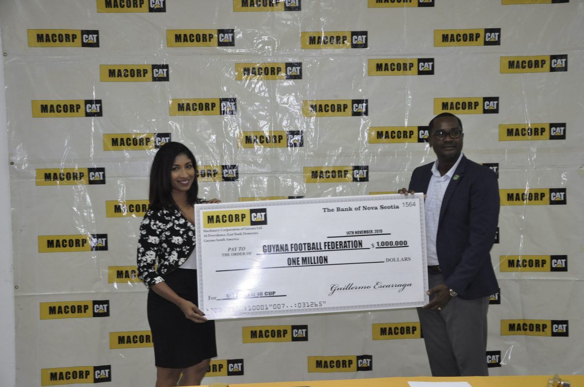 GFF President Wayne Forde collecting the sponsorship cheque from Chief Financial Officer/Human Resources Manager of MACORP Anita Ramprasad