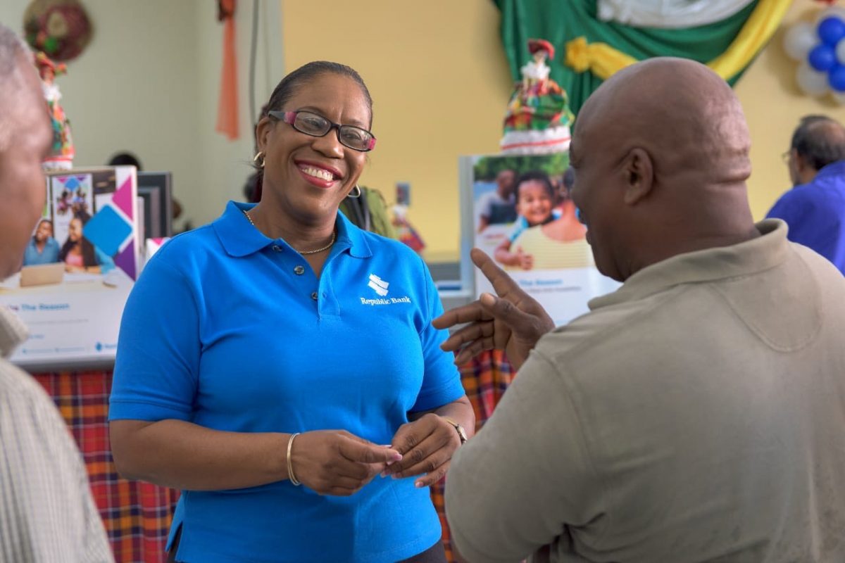 Gina Severin, Republic Bank Country Manager – Dominica, chats with a customer on opening day (Republic Bank photo)