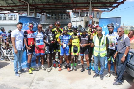 Marcus Keiler (centre with neon green and black) along with the top prize winners of the 20th Diamond Mineral Water 40-mile road race pose with their spoils yesterday. 