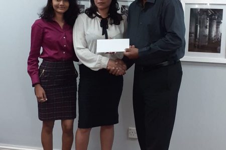 LGC President Aleem Hussain receives the sponsorship cheque from El Dorado Brand Manager, Maria Munroe (center) in the presence of Sara Ramjohn