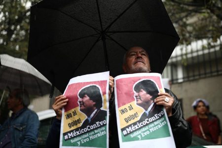 A man holds a sign during a demonstration in support of Bolivian President Evo Morales after he announced his resignation on Sunday, outside the Bolivian Embassy in Mexico City, Mexico, November 11, 2019. The sign reads, “No to the coup. Mexico with Evo. Solidarity with Bolivia and Evo Morales”. REUTERS/Edgard Garrido

