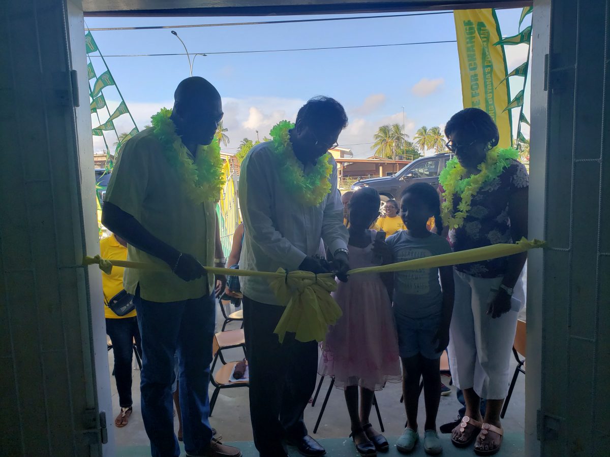 AFC Leader Khemraj Ramjattan along with Minister David Patterson and Minster Catherine Hughes and two children during the cutting of the ribbon to open the new office.  