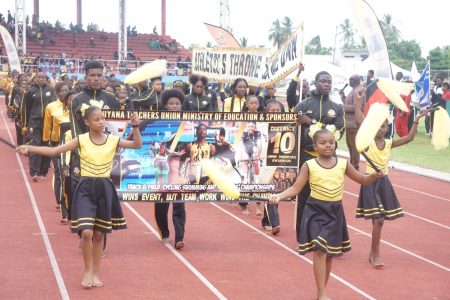 Defending champion athletes from Upper Demerara/Kwakwani (District 10) parading during the march past yesterday  at the opening ceremony of the 59th edition of the National Schools Cycling, Swimming and Track and Field Championships currently underway at the National Track and Field Centre. (Emmerson Campbell photo) 

