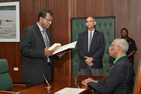 Minister of Public Security, Khemraj Ramjattan taking the oath of office before President David Granger on Wednesday. Ramjattan is performing the functions of Prime Minister in the absence of substantive prime minister, Moses Nagamootoo. (Ministry of the Presidency photo)

