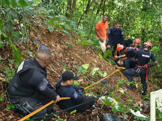 Rescuers taking Reuben Prout from a precipice off the North Coast Road.