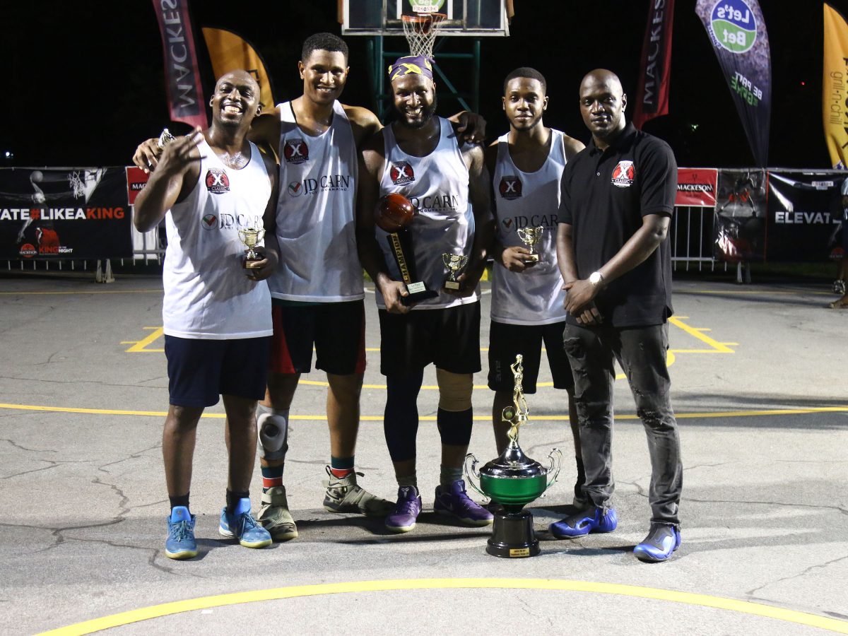 Members of the victorious Pit-bulls 3.0 side posing with their spoils alongside tournament coordinator Rawle Toney (right) after clinching the inaugural Rawle Toney/Mackeson 3×3 Basketball Champion ship. From left to right are Ryan Stephney, Jermin Slater, Ryan Gullen and Travis Belgrave
