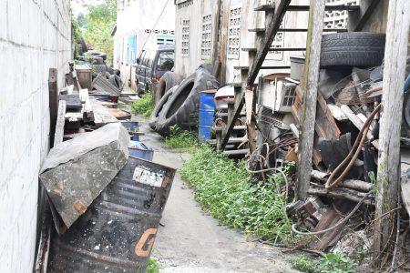 A section of the street blocked off by materials owned by the proprietor of the tyre shop. (Ministry of Public Infrastructure)