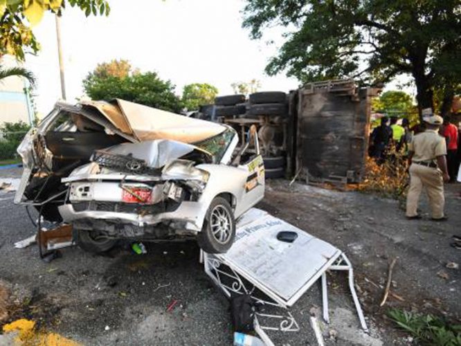 The wrecked taxi and the overturned garbage truck at the gate of the Clan Carthy Primary School in Kingston - Ricardo Makyn/JAMAICA GLEANER photo