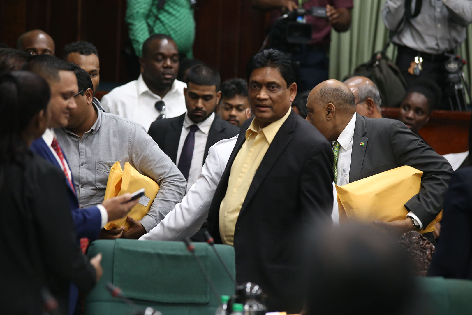 Former government MP Charrandass Persaud (at right in foreground) after his stunning vote in favour of the PPP/C’s motion of no-confidence against the government. (Stabroek News file photo)
