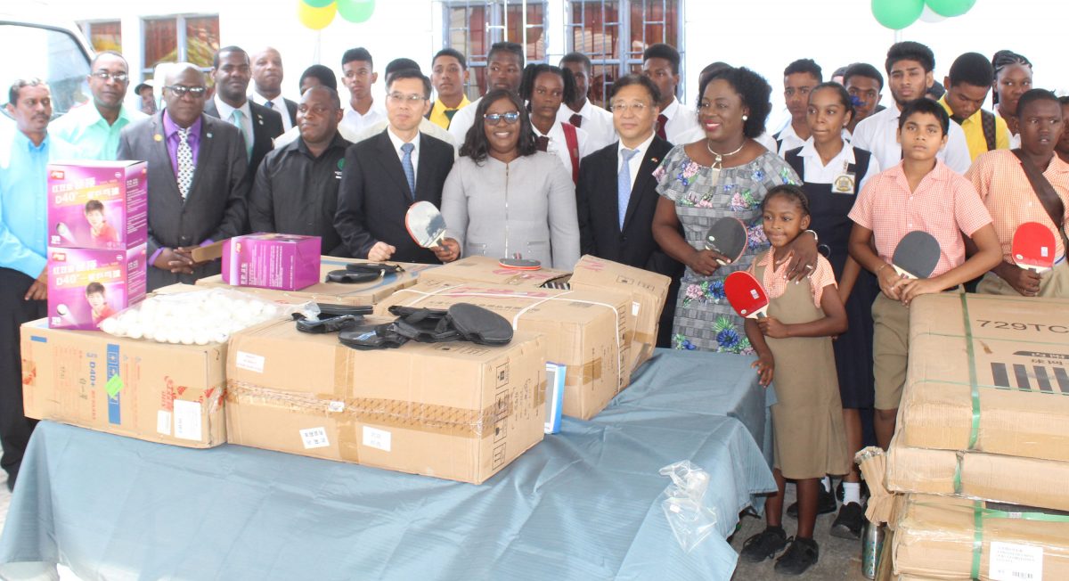Dr. Nicolette Henry, Ambassador Cui Jianchun, Dr. Karen Cummings,  Chen Xilai and other officials are flanked by school children who will benefit from yesterday’s donations.
