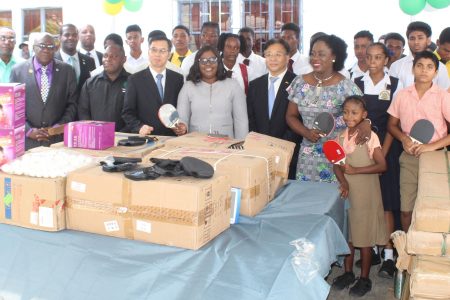 Dr. Nicolette Henry, Ambassador Cui Jianchun, Dr. Karen Cummings,  Chen Xilai and other officials are flanked by school children who will benefit from yesterday’s donations.
