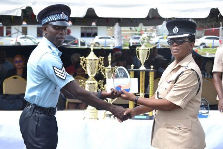 Best Cop Gladwin Hanover (left) receives one of his awards from Senior Superintendent Charmaine Stuart (DPI Photo)
