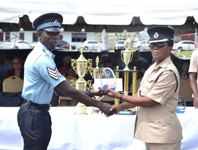 Best Cop Gladwin Hanover (left) receives one of his awards from Senior Superintendent Charmaine Stuart (DPI Photo)