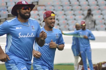 Captain Kieron Pollard (left) goes through his paces in a training session along with Lendl Simmons. (CWI photo)
