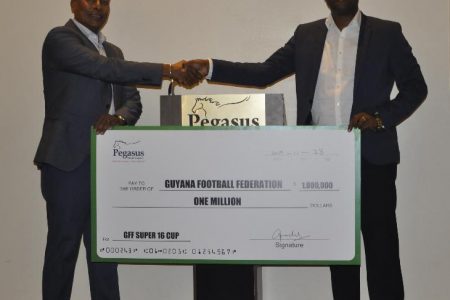 Robert Badal, left has donated one million dollars to Wayne Forde, right, and the Guyana Football federation for its end of year football tourney.
