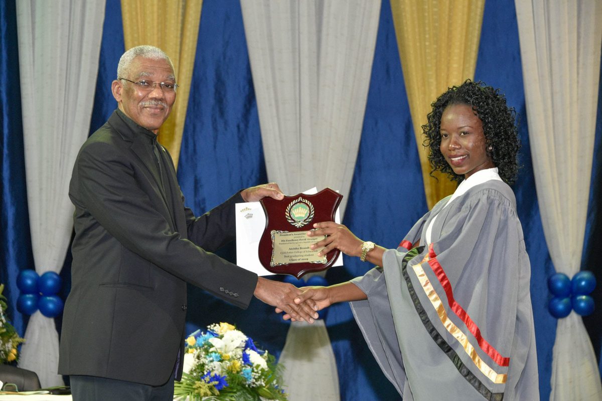President David Granger presents the President’s award to Ateisha Brandt, best graduating student of the Cyril Potter College of Education. (Ministry of the Presidency photo)