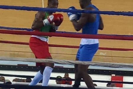 Action involving Desmond Amsterdam (blue) and Grenadian opponent,  Triston Brooks.
