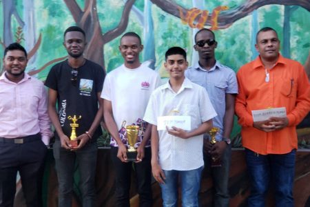 Manager of Outback Adventures Yuvindra Sookraj, sponsor of the Berbice Rapid Chess Tournament (left) with the winners of last Sunday’s Berbice Tournament. Standing next to Sookraj are (from left ) Davion Mars (third), Anthony Drayton (first), Omesh Dyal (Best Junior), Wendell Meusa (second) and Kriskal Persaud (Best Berbice Player).
