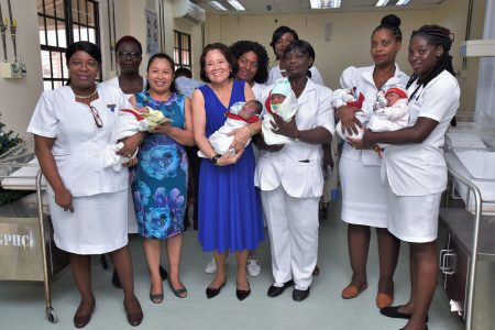 First five Christmas babies at GPHC: First Lady,  Sandra Granger (third from left) and Minister of State,  Dawn Hastings-Williams (second from left) and nurses of the Maternity Ward of the Georgetown Public Hospital Corporation (GPHC) posing with the first five babies delivered on Christmas Day. (Ministry of the Presidency photo)
