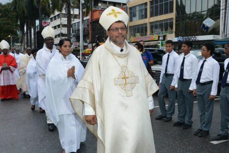 LEADING THE WAY: Rev Charles Jason Gordon leads a procession yesterday into the Cathedral of the Immaculate Conception in Port of Spain where he was installed as Archbishop. –Photo: ISHMAEL SALANDY