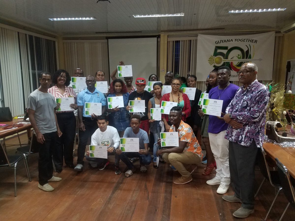 Some of the designers who participated in the workshop pose with their certificates. Also in the photo are Coordinator Dr Vibert Cambridge (right) and Trinidad-based Guyanese designer Antonio Butts (left).
