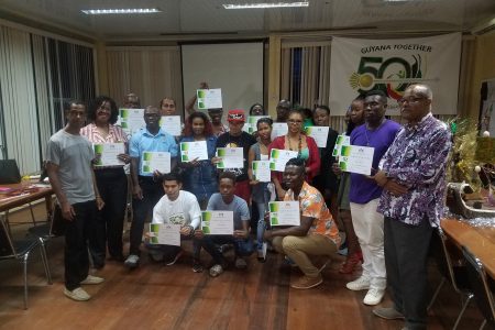 Some of the designers who participated in the workshop pose with their certificates. Also in the photo are Coordinator Dr Vibert Cambridge (right) and Trinidad-based Guyanese designer Antonio Butts (left).
