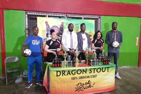 Dragon Stout Brand Manager Jamal Baird [third from right] and Director of Sports Christopher Jones [3rd from left] posing with members of the launch party for the Dragon Stout Street-ball ‘Community Cup.’ 