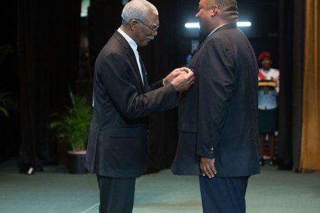 FLASHBACK! Incumbent President of the Berbice Cricket Board, Hilbert Foster (right) receiving his Medal of Service from President of Guyana, David Granger.