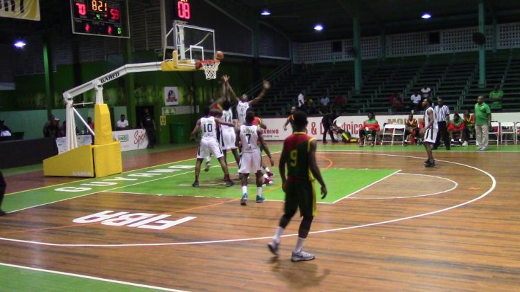 Scenes from the Guyana [white] and Grenada clash at the Cliff Anderson Sports Hall on the opening night of the Goodwill International Basketball Series
