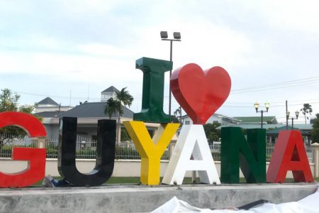 This soon to be launched `I love Guyana’ sign was erected on Saturday and has already generated much interest on social media. The sign is located opposite the Umana Yana.
The sign which is 12 feet in height by 34 feet in width has been constructed by the Tourism and Hospitality Association of Guyana (THAG) in partnership with Impressions Inc and GBTI.
THAG in a press release said the location will serve as a gathering point for visitors who desire to celebrate their travel here.  “It may as well be used as a starting or culmination point for tours across the city as well as outer lying locations,” THAG said.