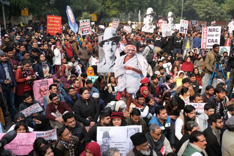 Demonstrators march during a protest against a new citizenship law in New Delhi on Dec. 24. Photographer: T. Narayan/Bloomberg