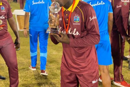 Sweet victory! Guyanese Kevin Sinclair kisses the Colonial Medical Insurance Super50 trophy he won with the West Indies Emerging Players
