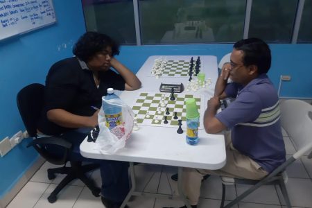  Candidate Master Taffin Khan (left) locked in battle with Shiv Nandalall.

