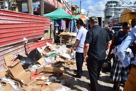 Mayor Ubraj Narine showing Chairman of the Private Sector Commission Gerry Gouveia the garbage situation on Regent Street(Photo courtesy Georgetown Mayor and City Council)