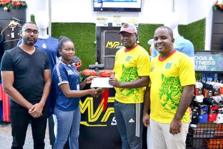 GFF Youth Development Officer Bryan Joseph (2nd from right) collects the sponsorship cheque from an MVP staffer in the presence of Manager Eon Ramdeo (left) and GFF PRO Keeran Williams.