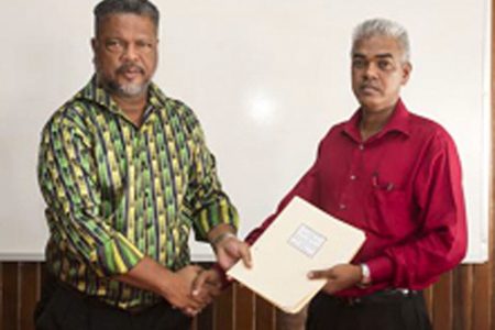 Charles Ogle (left), Chief Labour Officer, Department of Labour and Dawchan Nagasar, General Secretary-NAACIE shaking hands on the deal.